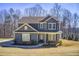 Charming two-story home features stone accents, a covered front porch, and professionally landscaped yard at 50 Crabapple Ridge Dr, Oxford, GA 30054