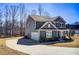 View of the home's exterior, highlighting the side-entry garage and long driveway at 50 Crabapple Ridge Dr, Oxford, GA 30054