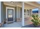 Inviting front porch with stone accents, white columns, and a charming welcome mat at 50 Crabapple Ridge Dr, Oxford, GA 30054