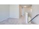 Bright hallway with carpeted floor, white banister, and neutral walls create a welcoming transition space at 50 Crabapple Ridge Dr, Oxford, GA 30054