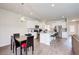 Open-concept kitchen featuring white cabinetry, stainless steel appliances, granite countertops, and a dining area at 50 Crabapple Ridge Dr, Oxford, GA 30054