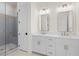 This bathroom features a double sink vanity, shower, and modern finishes at 528 Pearl St, Cumming, GA 30519