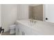 This bathroom features a white vanity, a sink, and gold hardware at 528 Pearl St, Cumming, GA 30519