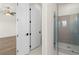 This bathroom has a walk-in shower with a glass door, and a double sink vanity at 528 Pearl St, Cumming, GA 30519