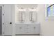 This bathroom features a double sink vanity with white cabinets and gold hardware at 528 Pearl St, Cumming, GA 30519