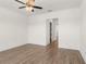 This bedroom features neutral colored walls, hardwood floors, and a ceiling fan at 528 Pearl St, Cumming, GA 30519