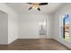 This bedroom features hardwood floors, a ceiling fan, a bathroom, and natural lighting at 528 Pearl St, Cumming, GA 30519