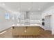 Bright, open kitchen featuring a large island, stainless steel appliances, and plenty of counter space at 528 Pearl St, Cumming, GA 30519