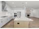 Modern kitchen with stainless steel appliances, large island, and an open view to the living area at 528 Pearl St, Cumming, GA 30519