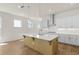 Spacious kitchen with a large island, stainless steel appliances, and ample counter space at 528 Pearl St, Cumming, GA 30519