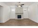 Living room features a modern fireplace, wood-look flooring, and recessed lighting at 528 Pearl St, Cumming, GA 30519