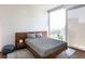 Relaxing bedroom with a comfortable bed, sleek nightstand, area rug and a large window with a view at 1080 Peachtree St # 2116, Atlanta, GA 30309