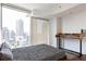 City views from the bedroom with a modern adjustable desk and comfortable queen bed at 1080 Peachtree St # 2116, Atlanta, GA 30309