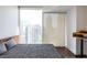 Bedroom featuring city views and featuring a comfortable bed with a modern desk to the right at 1080 Peachtree St # 2116, Atlanta, GA 30309