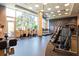 Well-equipped fitness center with cardio machines, weight equipment, and large windows at 1080 Peachtree St # 2116, Atlanta, GA 30309