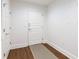 Bright foyer featuring hardwood floors, a textured rug, and a white door at 1080 Peachtree St # 2116, Atlanta, GA 30309