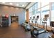 Spacious gym with a variety of equipment, including ellipticals, weights, and fitness balls at 1080 Peachtree St # 2116, Atlanta, GA 30309