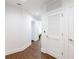 Inviting hallway with hardwood floors and white doors, providing access to various rooms at 1080 Peachtree St # 2116, Atlanta, GA 30309