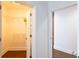 Hallway with access to a walk-in closet, featuring wooden floors and modern trim at 1080 Peachtree St # 2116, Atlanta, GA 30309