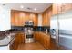 Contemporary kitchen with stainless steel appliances, wood cabinets, and granite countertops at 1080 Peachtree St # 2116, Atlanta, GA 30309