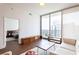 Open floor plan with hardwood floors, a seating area, and expansive city views at 1080 Peachtree St # 2116, Atlanta, GA 30309
