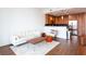 Cozy living room open to the kitchen, featuring modern furnishings and hardwood floors at 1080 Peachtree St # 2116, Atlanta, GA 30309