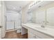 Bright bathroom featuring a large mirror, white vanity, toilet, and a shower with glass door at 302 Gladstone Dr, Mcdonough, GA 30253