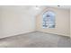 This bedroom features vaulted ceiling, large window, and plush carpet, offering a peaceful retreat for rest and relaxation at 302 Gladstone Dr, Mcdonough, GA 30253