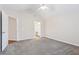 Well-lit bedroom with neutral tones, soft carpet, and easy access to adjacent rooms at 302 Gladstone Dr, Mcdonough, GA 30253
