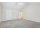 This bedroom features high ceilings, two entry doors, plush carpet, and ample space for relaxation and rest at 302 Gladstone Dr, Mcdonough, GA 30253