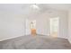 Spacious bedroom with vaulted ceiling, plush carpet, and access to an en-suite bathroom at 302 Gladstone Dr, Mcdonough, GA 30253