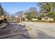 Gated community entrance featuring brick columns and lush landscaping at 302 Gladstone Dr, Mcdonough, GA 30253