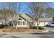 Charming single-story home featuring a stone facade, arched windows, and well-maintained landscaping at 302 Gladstone Dr, Mcdonough, GA 30253