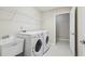 Spacious laundry room with sink, washer, dryer, shelving, and room for all your laundry needs at 302 Gladstone Dr, Mcdonough, GA 30253