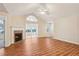 Bright living room showcasing hardwood floors, vaulted ceilings and inviting fireplace at 302 Gladstone Dr, Mcdonough, GA 30253