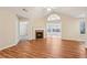 Bright living room showcasing hardwood floors, vaulted ceilings and inviting fireplace at 302 Gladstone Dr, Mcdonough, GA 30253