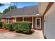 Home exterior with brickwork, red shutters, well maintained lawn, and attached garage at 217 Crystal Ct, Hampton, GA 30228