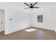 Bedroom with wood-look floors, large window, and contemporary ceiling fan at 2396 Lawrenceville Hwy # V, Decatur, GA 30033