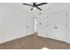 Bedroom features wood-look floors, closet with white doors, and contemporary ceiling fan at 2396 Lawrenceville Hwy # V, Decatur, GA 30033