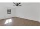 Bedroom with wood-look floors, large window, and contemporary ceiling fan at 2396 Lawrenceville Hwy # V, Decatur, GA 30033