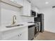 Modern kitchen featuring stainless steel appliances, a gold faucet and wood floors at 2396 Lawrenceville Hwy # V, Decatur, GA 30033