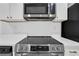 Kitchen features stainless steel electric stove top with mounted stainless steel microwave above at 2396 Lawrenceville Hwy # V, Decatur, GA 30033