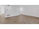 Spacious living room featuring wood floors, white walls, recessed lighting and multiple entry doors at 2396 Lawrenceville Hwy # V, Decatur, GA 30033