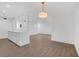 Open concept living room with views of the wood floors and a white kitchen at 2396 Lawrenceville Hwy # V, Decatur, GA 30033