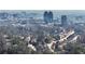 An aerial view of the property's neighborhood featuring mature trees and city views at 6275 Hunting Creek Rd, Atlanta, GA 30328