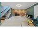 Spacious carpeted basement with a brick fireplace, stairs to upper level, and ample room for recreation at 6275 Hunting Creek Rd, Atlanta, GA 30328