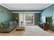 Inviting carpeted basement featuring access to patio and natural light through sliding glass door at 6275 Hunting Creek Rd, Atlanta, GA 30328