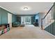 Comfortable carpeted basement with walkout to patio, painted wood paneling, and stairs to the upper level at 6275 Hunting Creek Rd, Atlanta, GA 30328