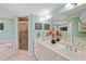 Bathroom featuring double sink vanity, a soaking tub, separate glass shower, and tiled floors at 6275 Hunting Creek Rd, Atlanta, GA 30328