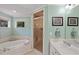 Bathroom featuring a soaking tub, glass shower and vanity with great lighting at 6275 Hunting Creek Rd, Atlanta, GA 30328